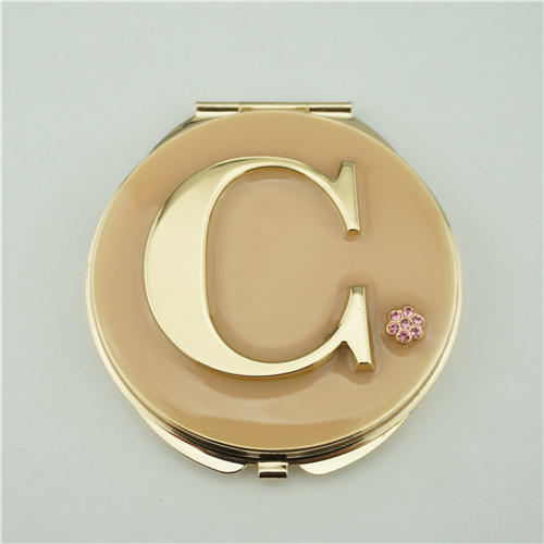 Personalized compact mirror with a raised initial C and small crystal flower