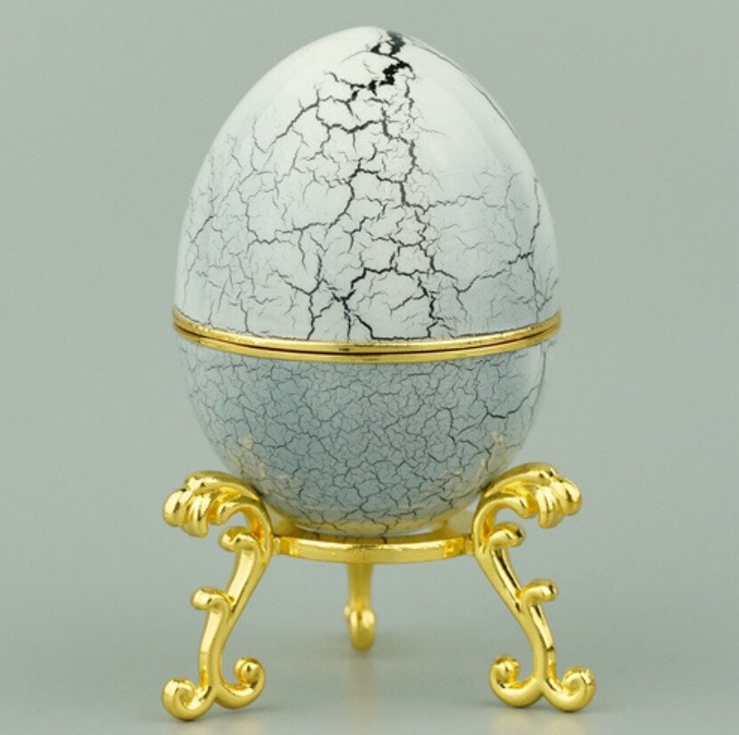 Black and grey crackle enamel Hen Egg reproduction on a gold-plated stand