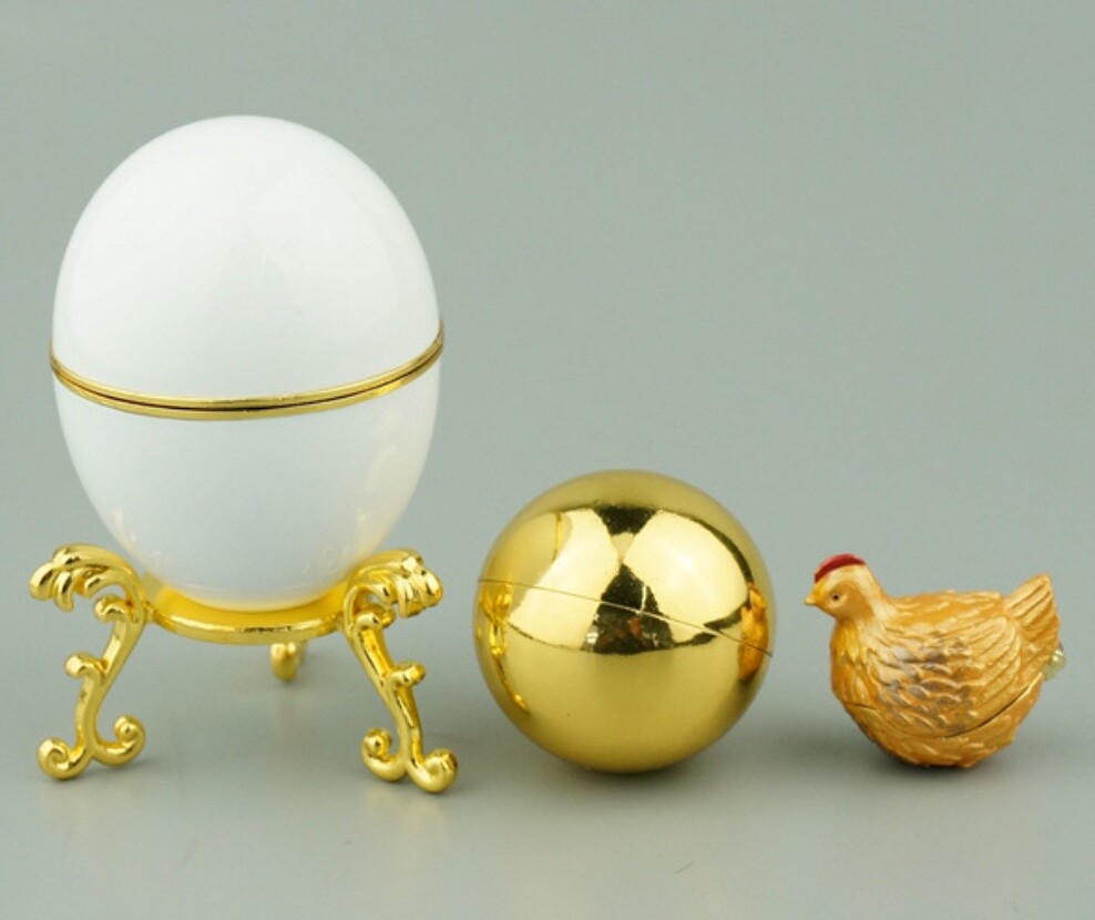 Complete 1885-inspired Hen Egg reproduction with white enamel shell, golden yolk and miniature hen