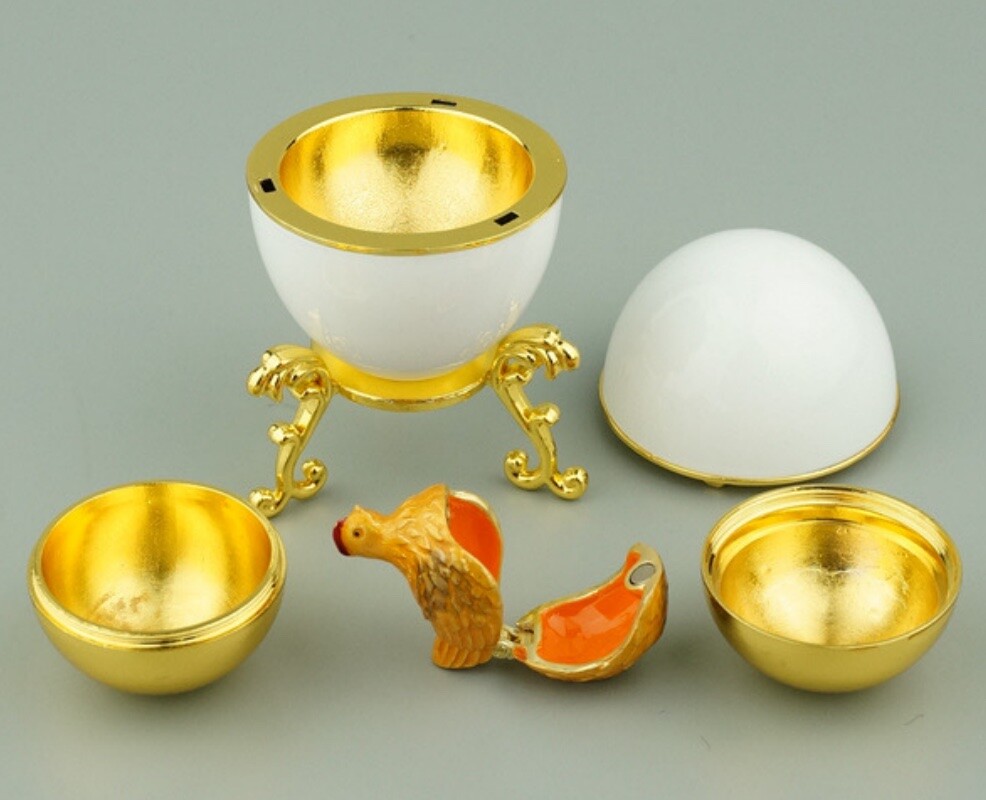Disassembled Hen Egg reproduction showing the shell, golden yolk and hinged miniature hen