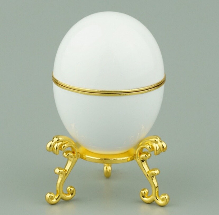 Closed white enamel Hen Egg reproduction on a gold-plated stand