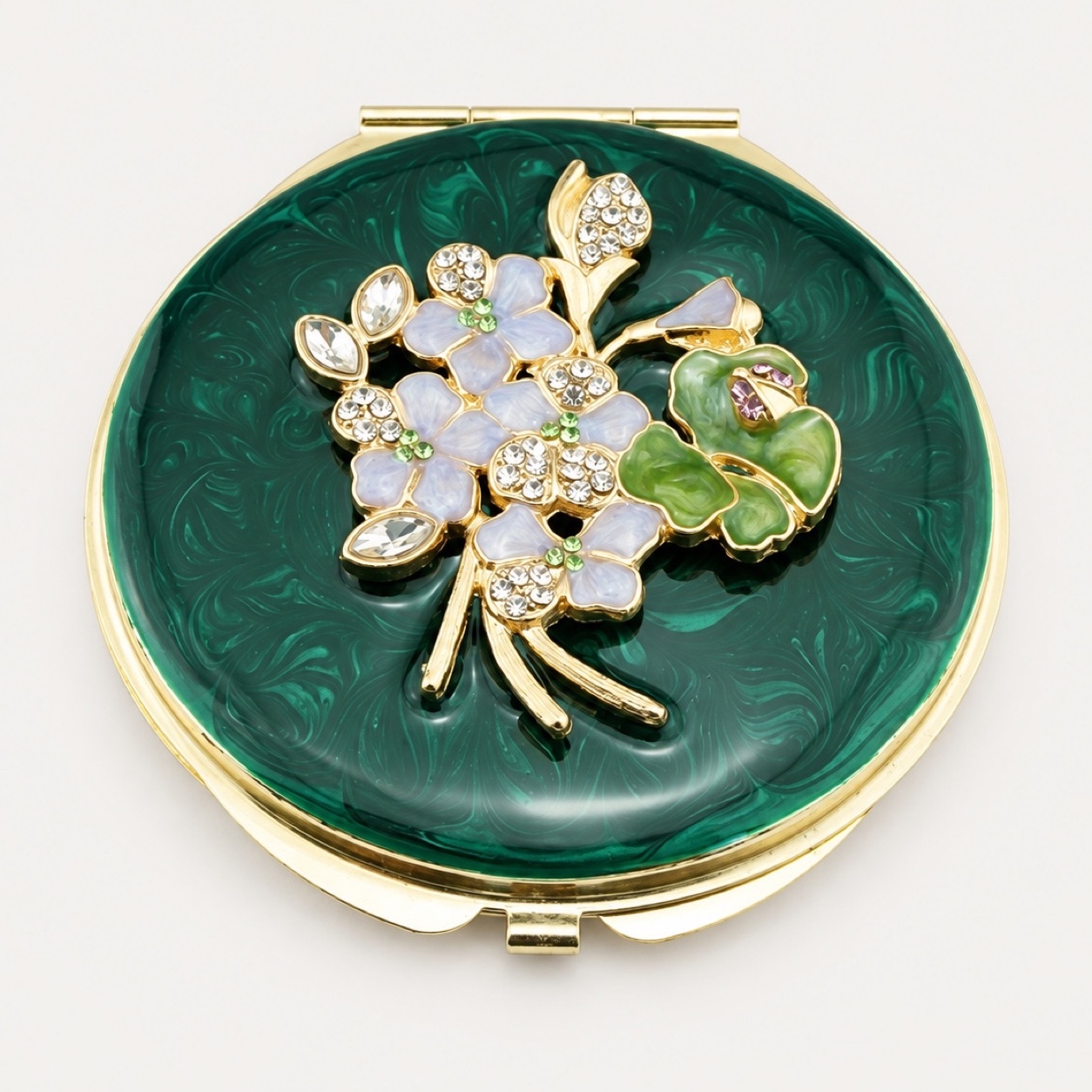 Green enamel compact mirror with a jeweled floral metal charm