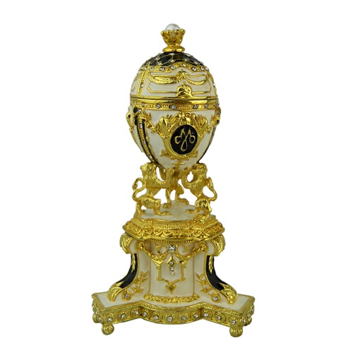Black, white and gold imperial monogram egg on an ornate pedestal