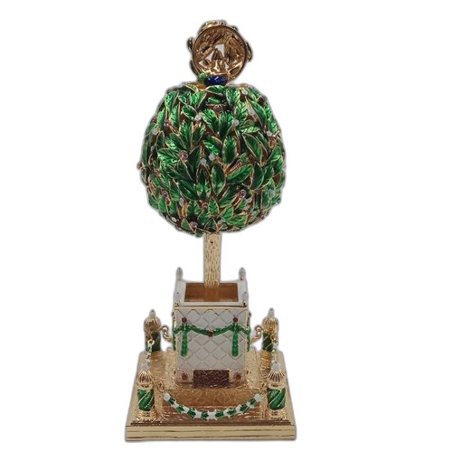 Collectible green topiary egg opened to reveal its surprise