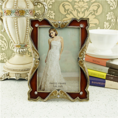 An amber-to-brown translucent enamel photo frame with gold filigree
