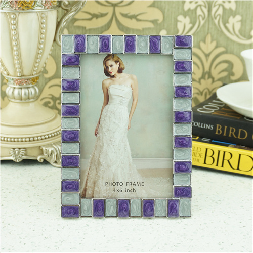 A purple and pearl-white photo frame with swirled enamel-look mosaic tiles