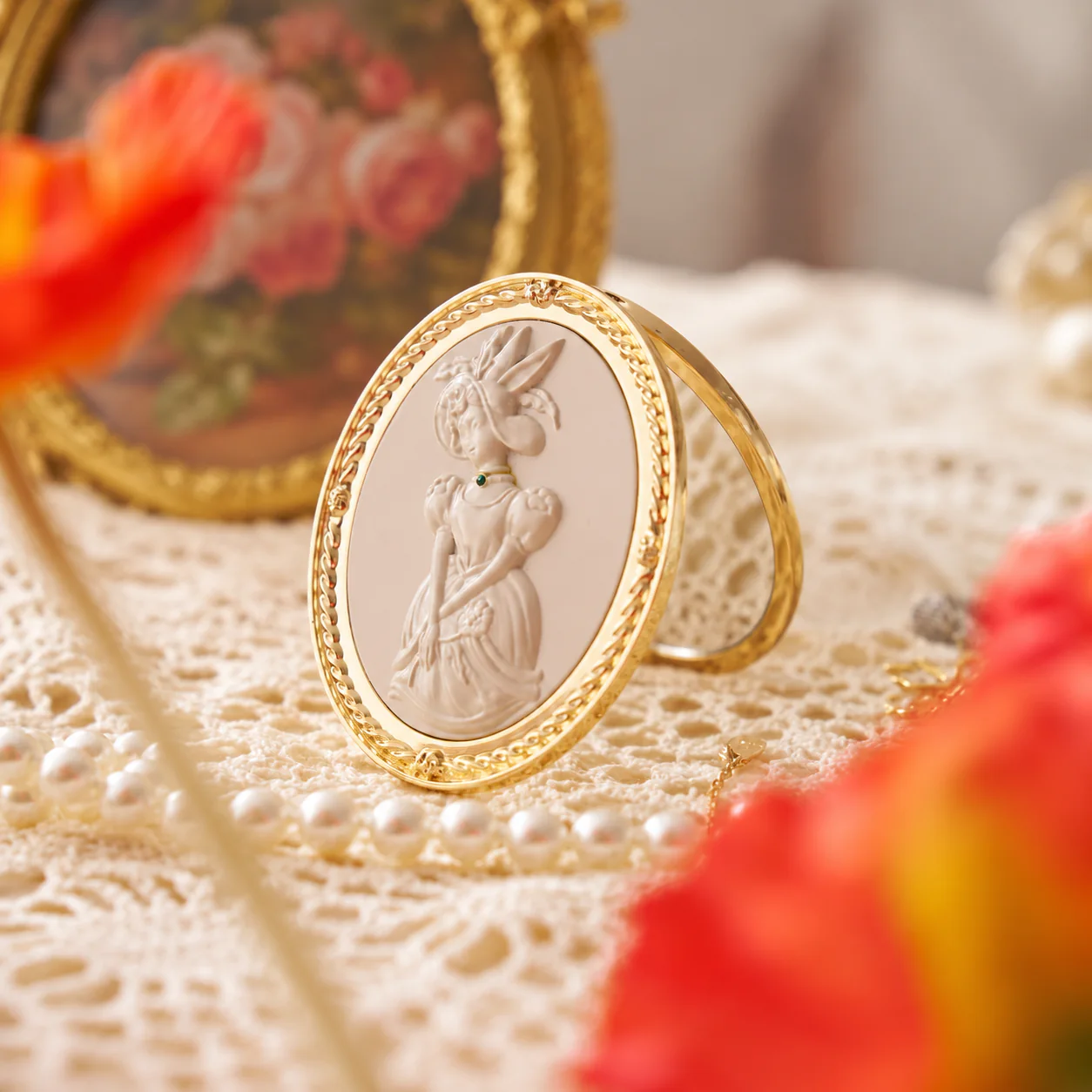 Custom cameo-style metal compact mirror in a styled display