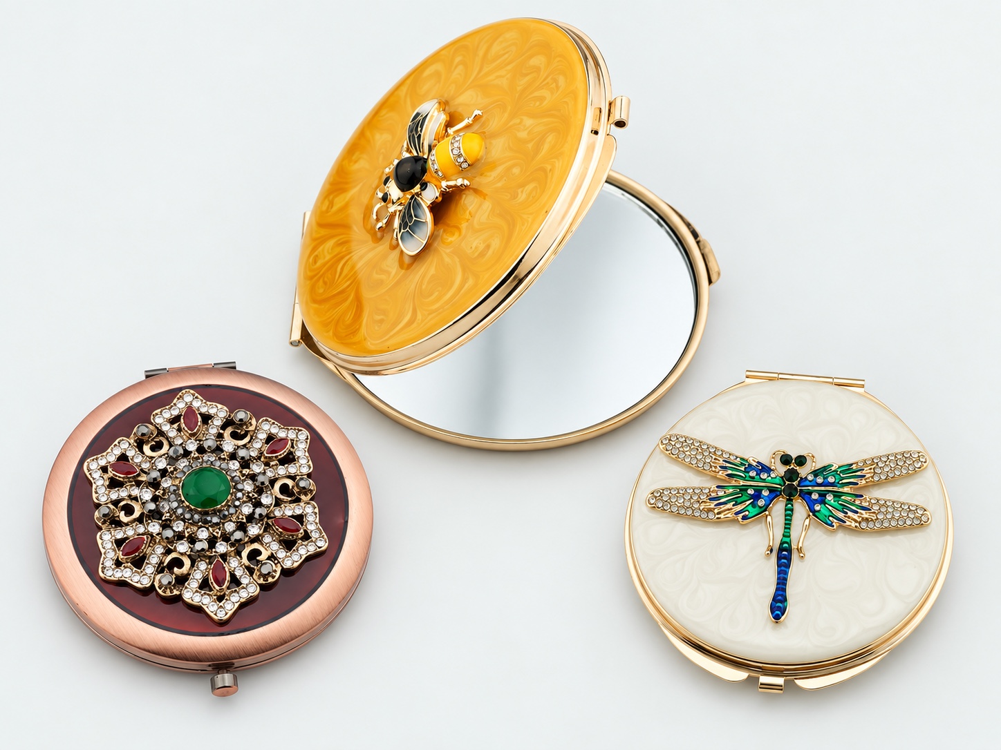 A varied collection of decorative metal compact mirrors